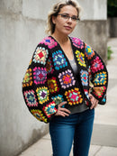 Vibrant Granny Blossom Cardigan, Front View with Outdoor Background, Multicolor Crocheted Sweater